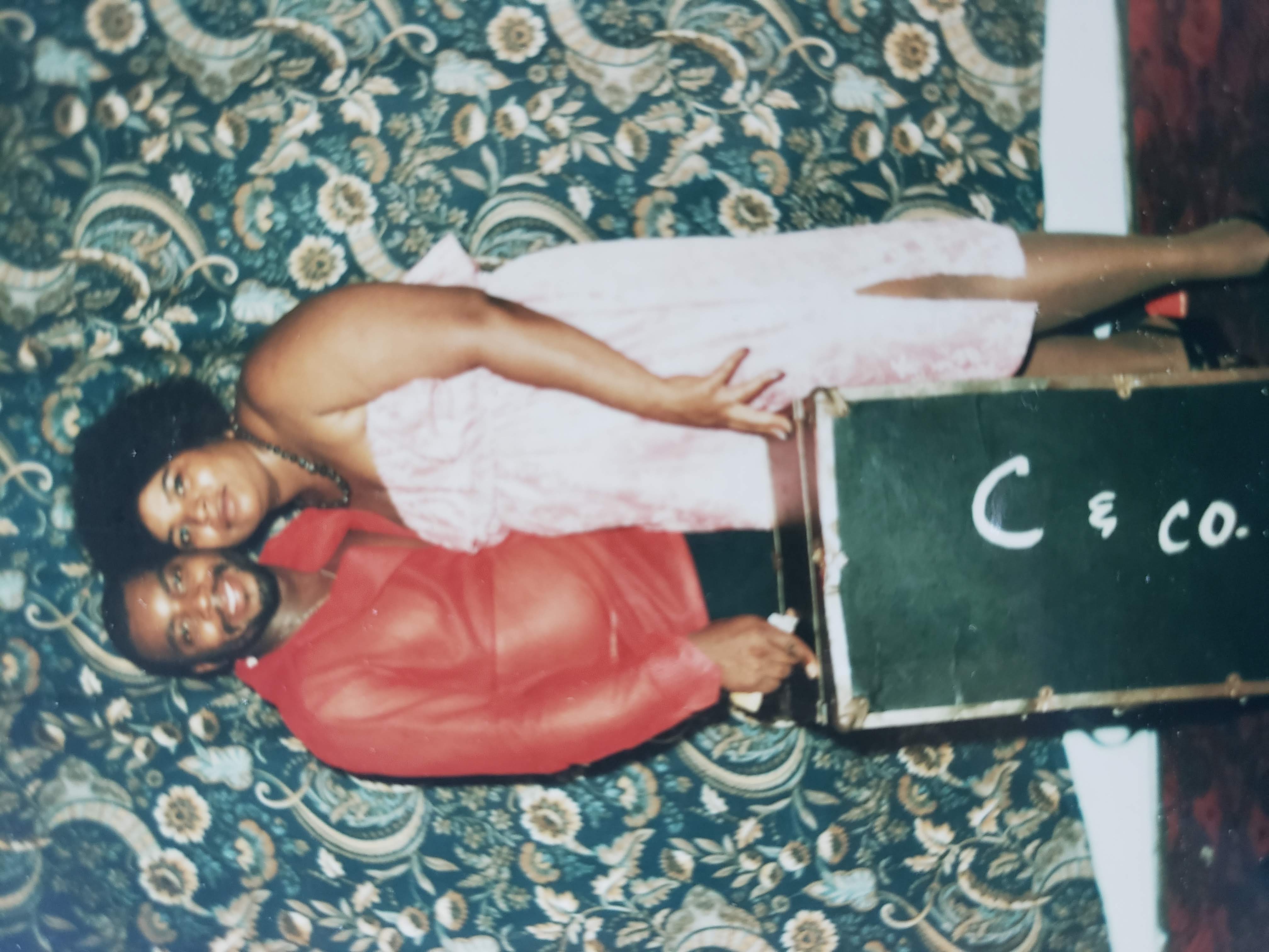 Gilbert and Delores Cassell, Gloria D. Cassell’s parents, standing together beside a speaker cabinet.
