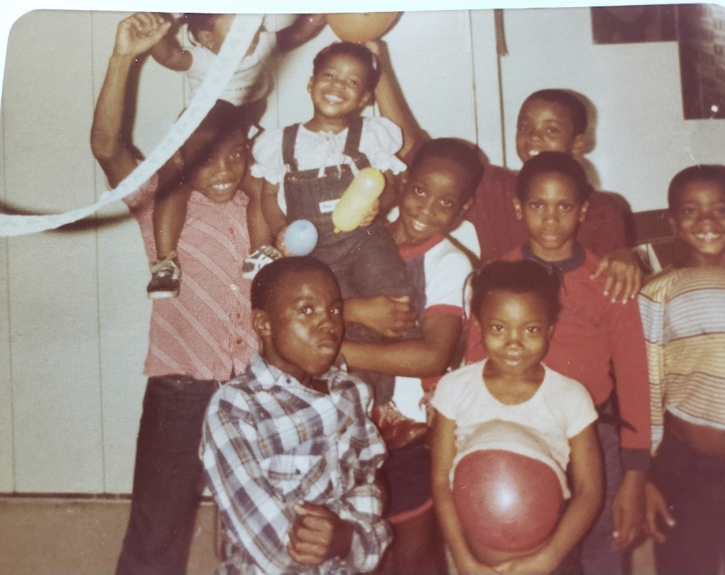 Gloria D. Cassell pictured as a child with siblings and cousins at a family gathering.